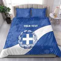 Blue and white bedding set featuring Greece crest emblem and “YOUR TEXT” across duvet