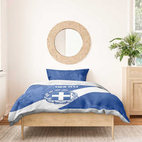 Blue and white bedding set with Greece crest emblem and “YOUR TEXT” on duvet center