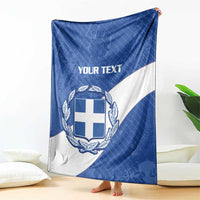 Blue and white Greece football blanket draped with crest and 'YOUR TEXT' heading