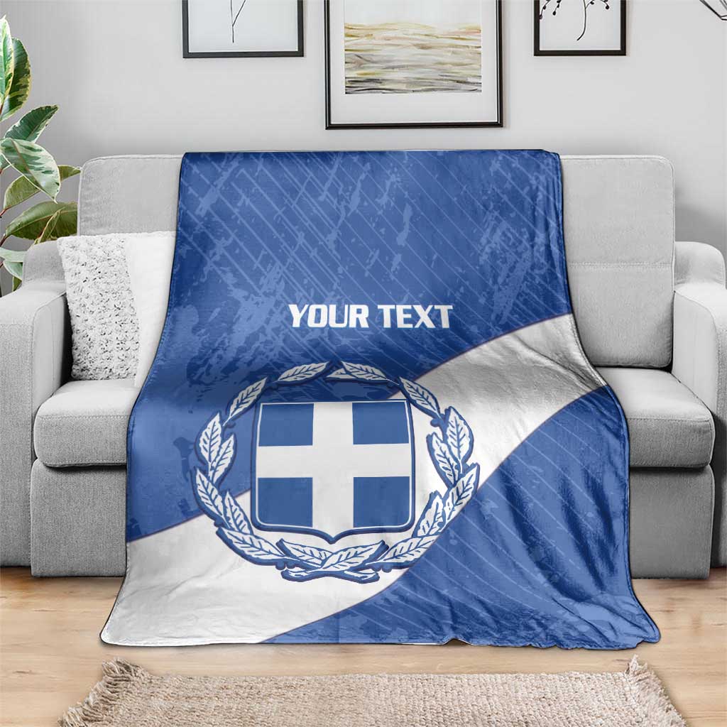 Blue and white Greece football blanket spread on a sofa with crest and 'YOUR TEXT'