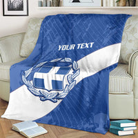Blue and white Greece football blanket on a couch with crest and 'YOUR TEXT' banner