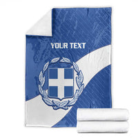Folded blue and white Greece football blanket with crest and 'YOUR TEXT', with rolled towels