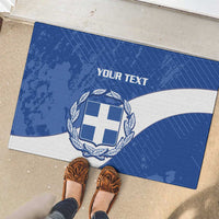 Blue rubber doormat with Greece emblem shield, laurel wreath, and customizable “YOUR TEXT”