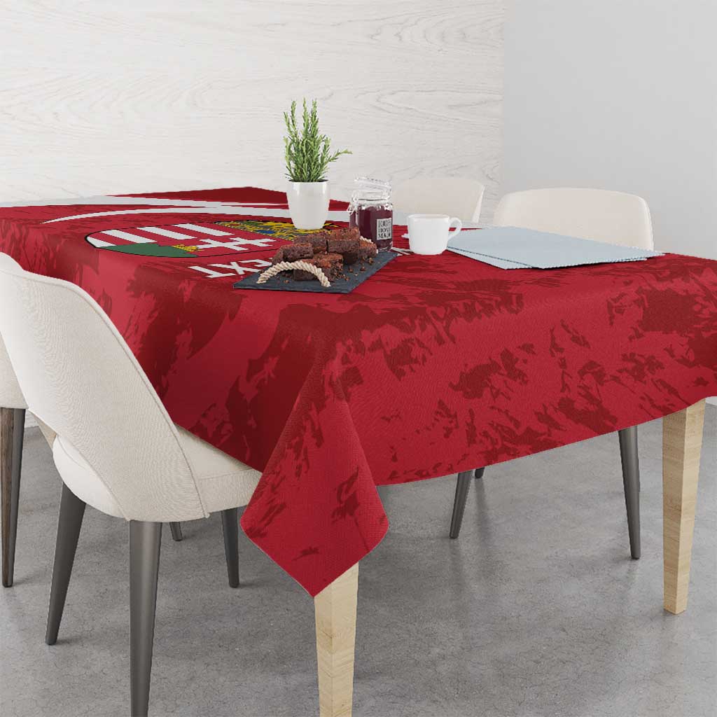 Red Hungary football tablecloth on table, showing crest and white curved stripes