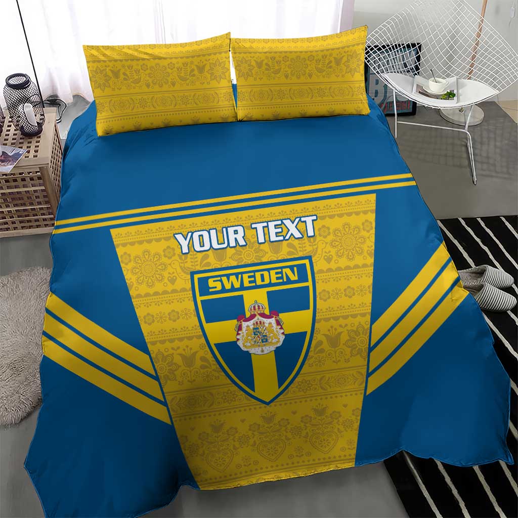 Blue-and-yellow duvet bedding set with Sweden crest and custom text, two yellow pillowcases.