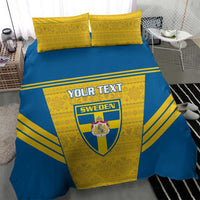 Blue-and-yellow duvet bedding set with Sweden crest and custom text, two yellow pillowcases.