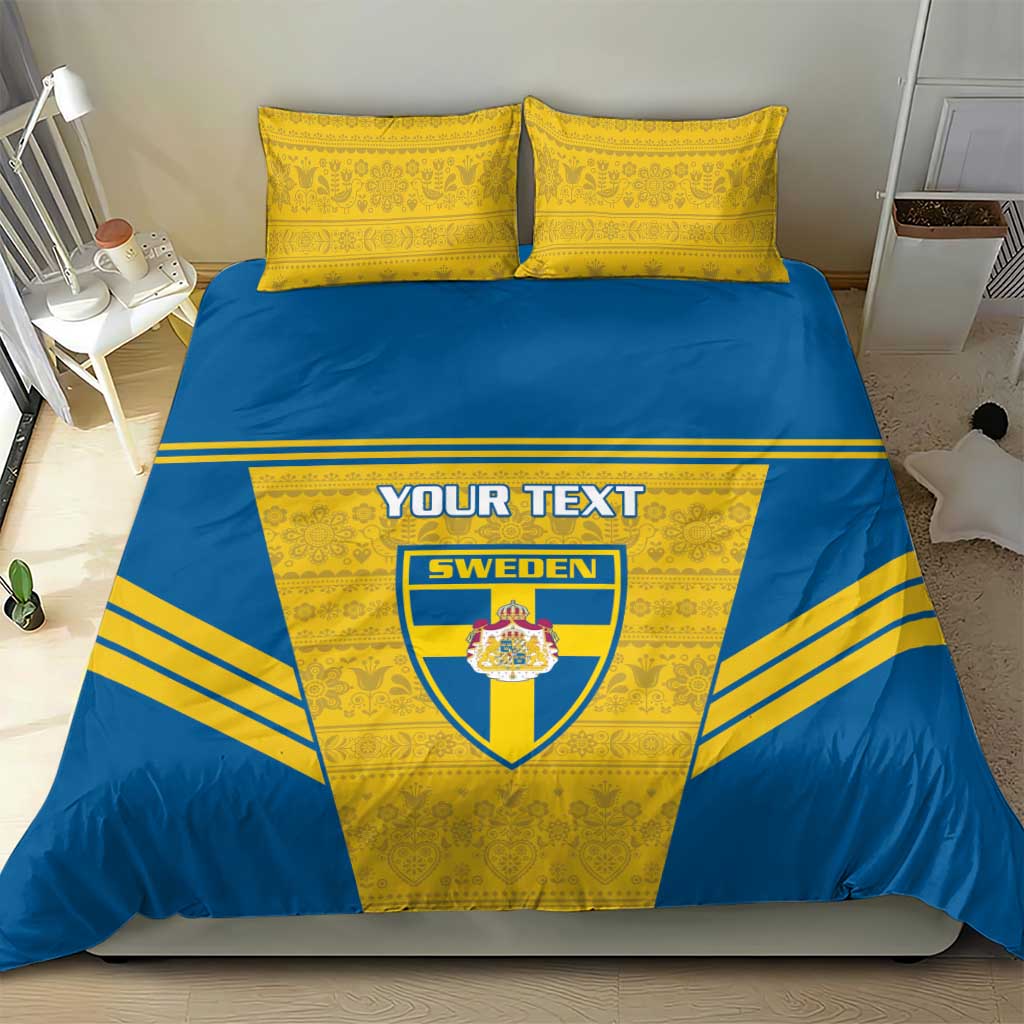 Blue-and-yellow bedding set featuring Sweden crest and custom text on the duvet, two pillows.