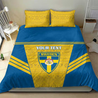 Blue-and-yellow bedding set featuring Sweden crest and custom text on the duvet, two pillows.
