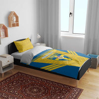 Blue-and-yellow Sweden-themed bedding set with crest and custom text on duvet, two pillows.