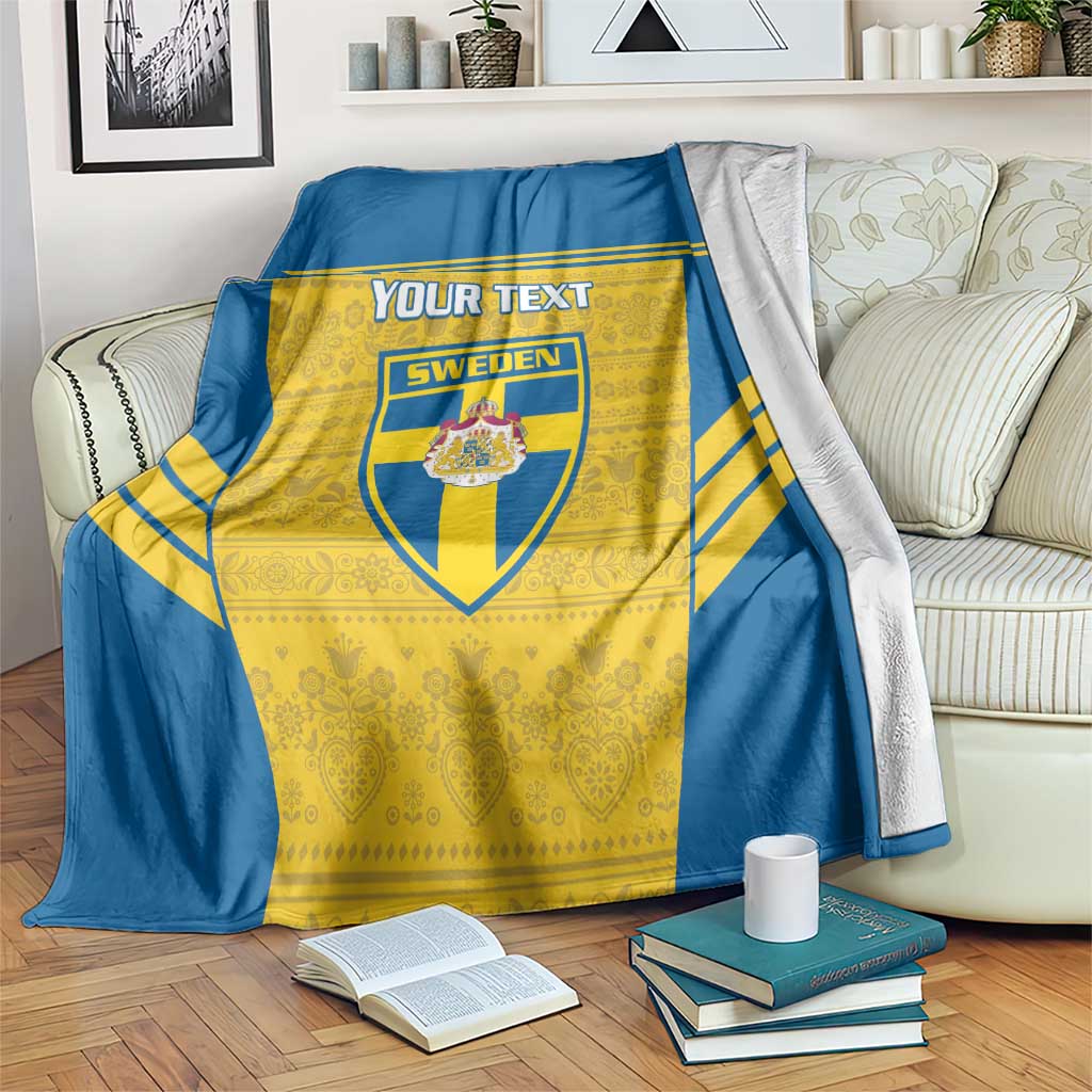 Blue and yellow Sweden football blanket with custom text area and crest, draped on couch