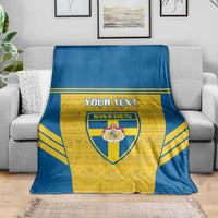 Blue and yellow Sweden football blanket with custom text and crest, laid across couch