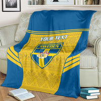 Blue and yellow Sweden football blanket with custom text and crest, draped on loveseat