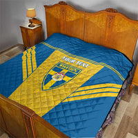 Blue and yellow Sweden quilt on bed with “YOUR TEXT” and Sweden shield crest
