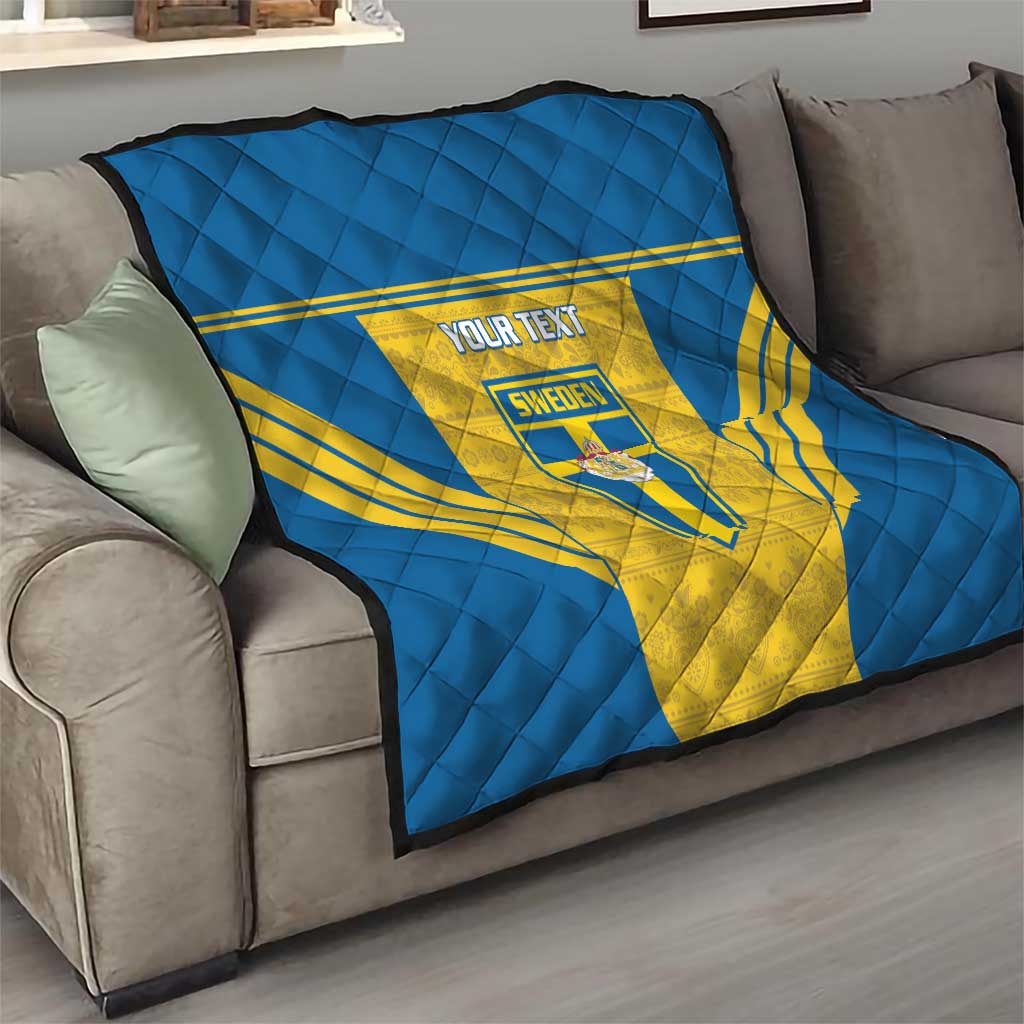 Blue and yellow Sweden quilt throw with “YOUR TEXT” and shield crest on sofa
