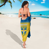 Blue and gold Sweden football sarong with crest panel and custom text, worn beach wrap