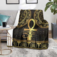 Black Egyptian blanket laid on sofa with centered gold Ankh and Eye of Horus