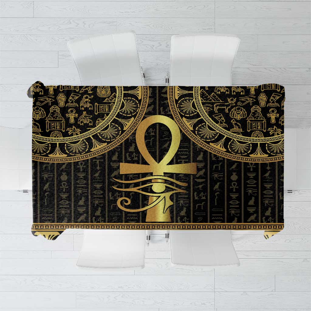 Black Egyptian tablecloth close-up with gold ankh medallion and hieroglyph pattern
