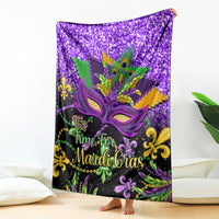 Purple Mardi Gras blanket featuring decorative mask, peacock feathers, and “Time for Mardi Gras” text