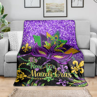 Purple Mardi Gras throw blanket with purple glitter background, mask artwork, and fleur-de-lis accents