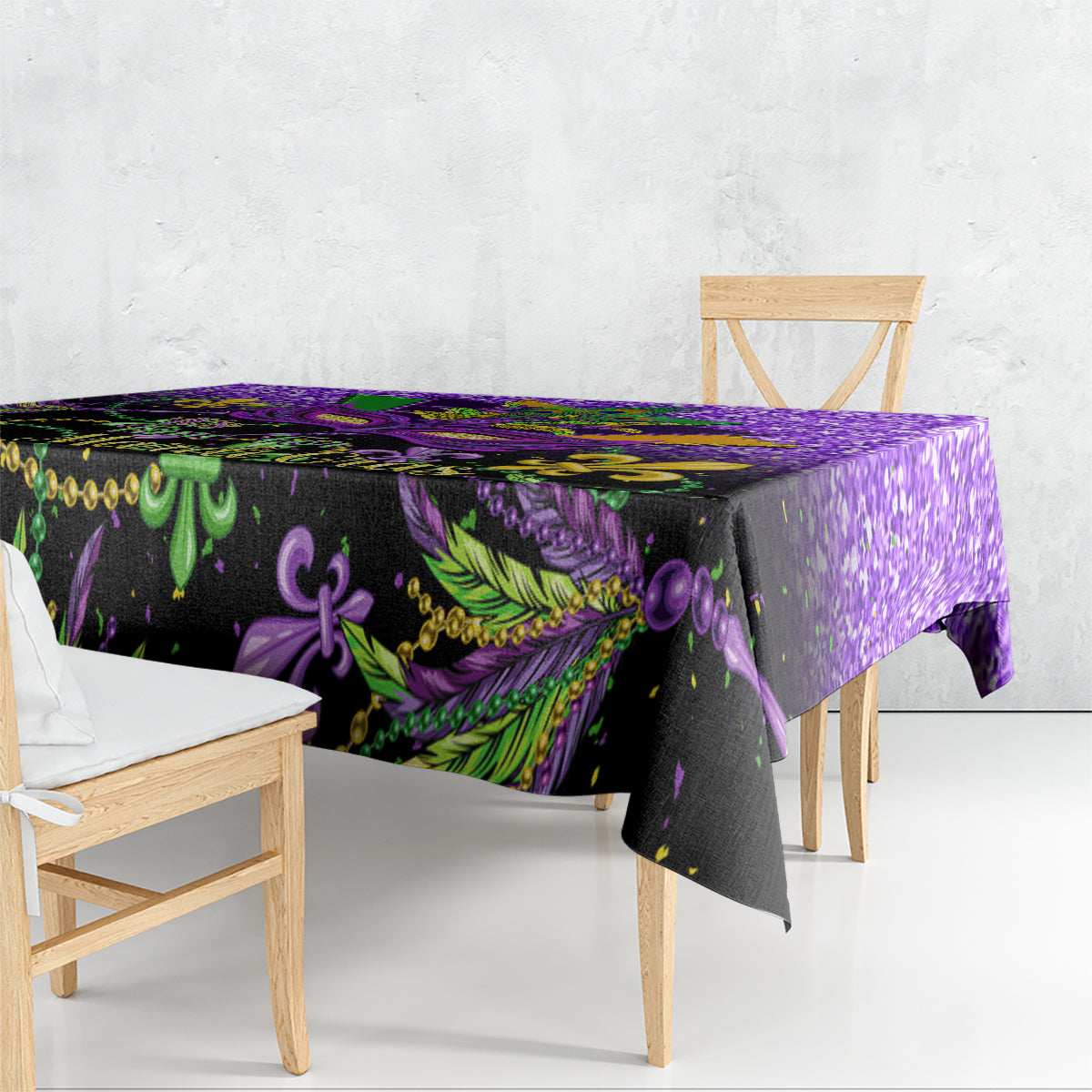 Purple Mardi Gras tablecloth draped on table with green and gold feathered mask motifs
