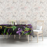 Purple Mardi Gras tablecloth with dark base, glitter pattern, fleur-de-lis, and feather artwork