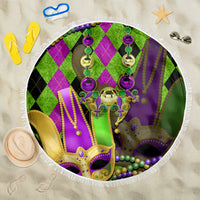 Round Mardi Gras beach blanket with colorful jester mask and hanging bead fringe