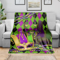 Purple and green jester mask throw blanket with fleur-de-lis accents and bead garland trim