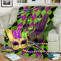 Colorful Mardi Gras jester mask blanket in purple, green, and black with bead strands