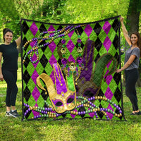Mardi Gras jester mask quilt, full view on grass, purple-green diamonds with bead trim