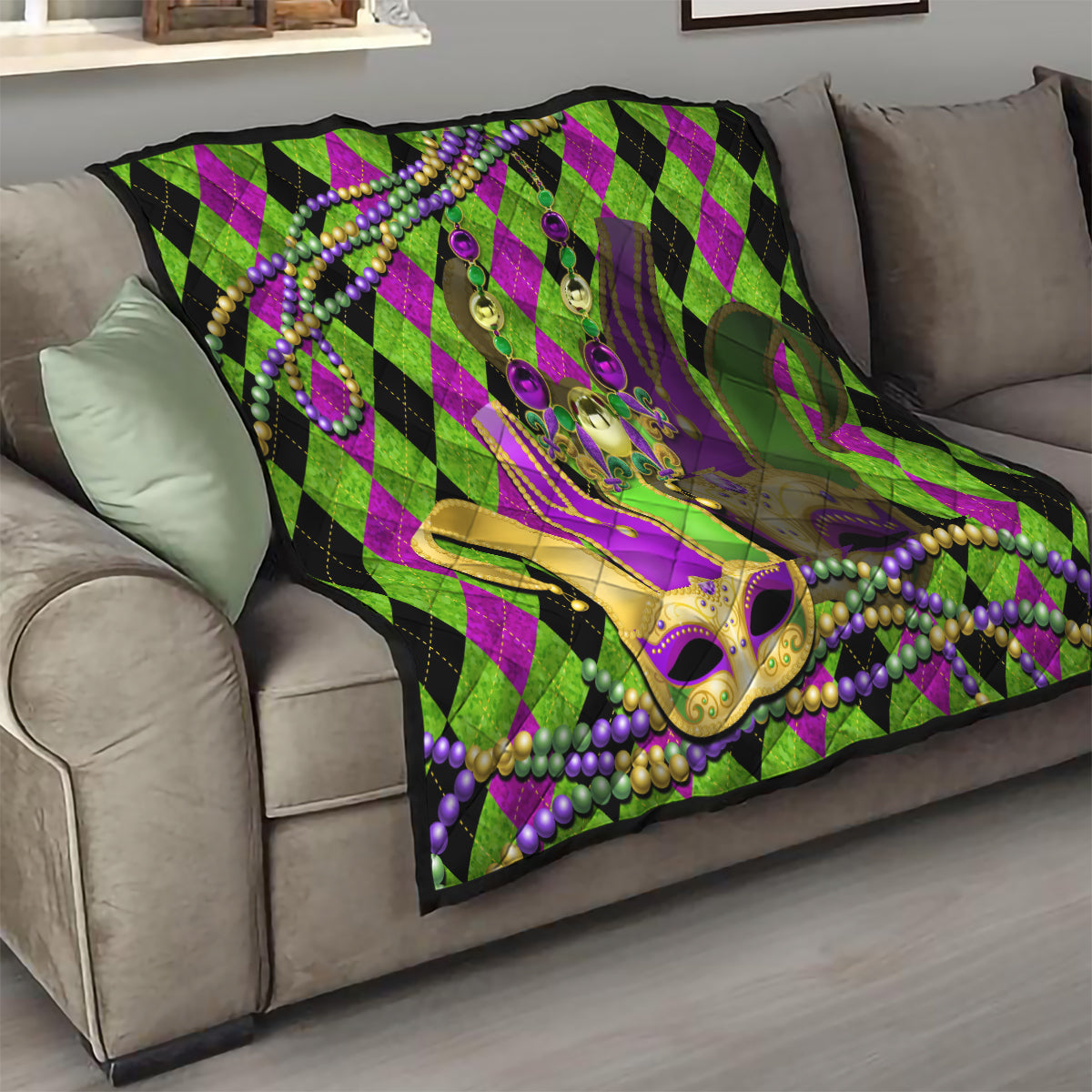 Mardi Gras jester mask quilt draped on sofa, purple-green diamond pattern and bead trim
