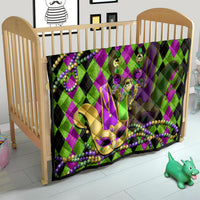 Mardi Gras jester mask quilt over crib, purple-green diamond fabric with bead necklace design