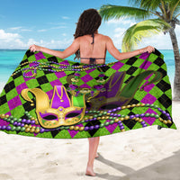 Green purple diamond jester sarong with central gold mask and purple bead fringe