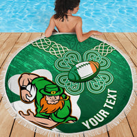 Green round beach blanket with white fringe, rugby player and Celtic knot design