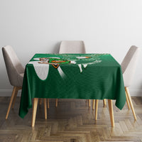 Green tablecloth with Celtic knot shamrock panel and rugby mascot graphic across the top.