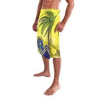 Yellow lavalava shorts with blue geometric panel, palm tree, and badge graphic