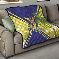 Quilt on a living room sofa with blue and yellow quilted texture; eagle and palm design.