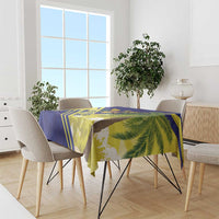 Blue, yellow, and green tablecloth with tropical palm print and geometric stripes