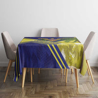 Blue and yellow tablecloth with green accents, set on dining table with chairs