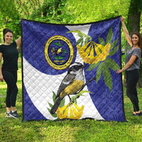 Blue quilt blanket featuring bird artwork, banana-yellow leaves, and seal emblem