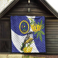 Blue quilt displayed on a doorway with bird artwork, tropical leaves, and seal logo
