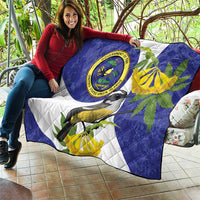 Blue quilt held on outdoor couch featuring banana-yellow leaves, bird, and seal