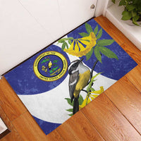 Blue rubber doormat featuring bird perched on branch with yellow blossoms and round emblem.