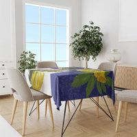 Blue tablecloth with bird-and-flower print covering a dining table