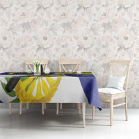 Blue tablecloth with tropical bird and yellow flower print on dining table