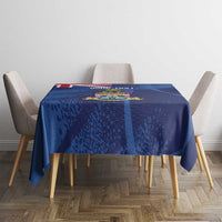 Blue grunge-style tablecloth featuring Cayman coat of arms on dining table