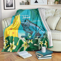 Turquoise tropical blanket with blue iguana, palm leaves, flowers, and 'Cayman Islands' text