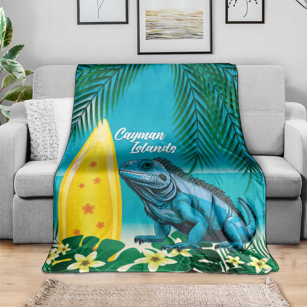 Turquoise tropical blanket with blue iguana, palm leaves, and 'Cayman Islands' text