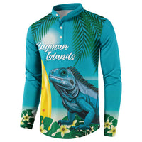Turquoise button sweatshirt with iguana surfing graphic and leaf pattern across front