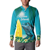 Turquoise button sweatshirt with “Cayman Islands” text and iguana surfing graphic