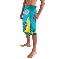 Turquoise tropical print swim shorts with blue lizard and surfboard, side angle view
